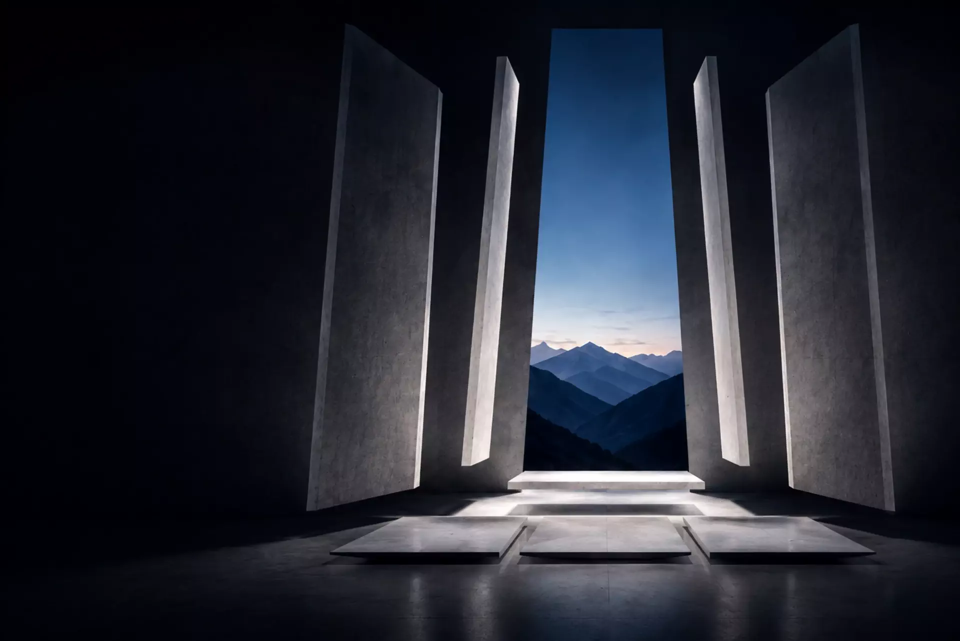 Monumental concrete walls splayed open onto layered mountain ranges at dusk